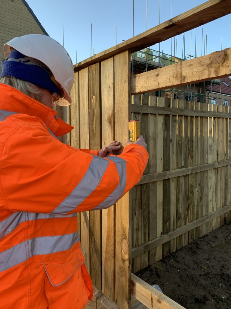 An Instructor checking a fence a student worked on in their level 2 diploma in fencing.